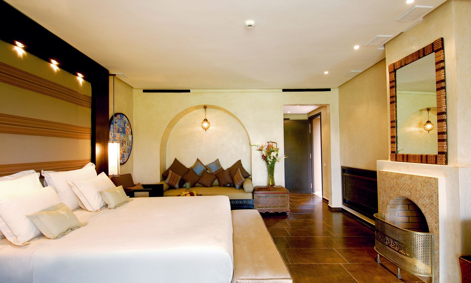 A warmly lit S-Heema suite with a fireplace and layered textiles